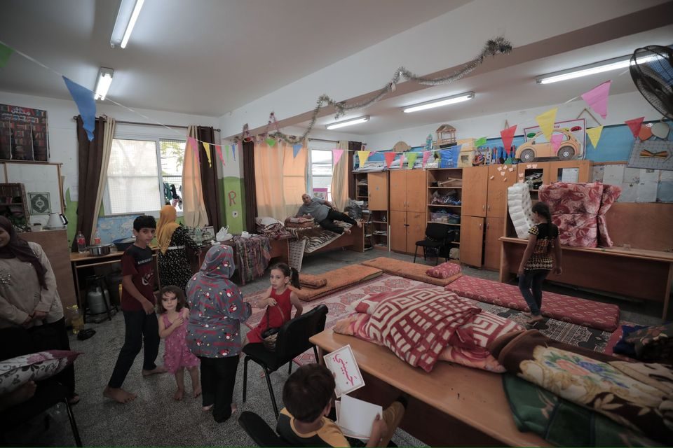 فلسطينيون ينزحون إلى مدارس وكالة الأونروا في قطاع غزة للاحتماء من القصف المدمر/ الأونروا