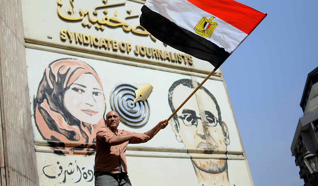 صورة لمتظاهر يحمل علم مصر أمام نقابة الصحفيين المصريين/ جيتي