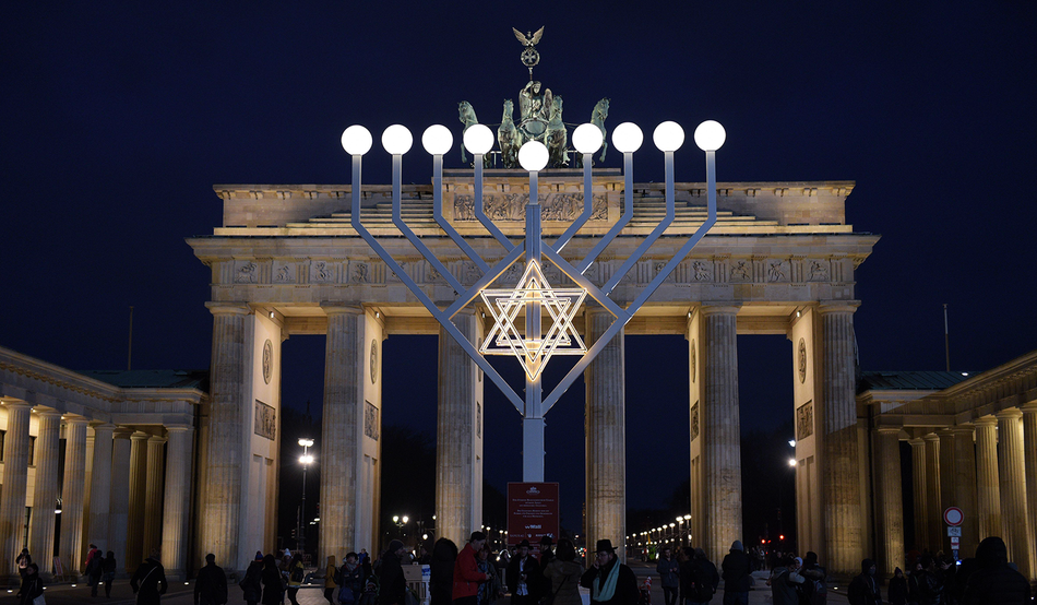 شمعدان هانوكا الذي تستخدمه إسرائيل كرمز لها مع النجمة السداسية٬ عند بوابة براندنبورغ رمز مدينة برلين/ أرشيفية (رويترز)